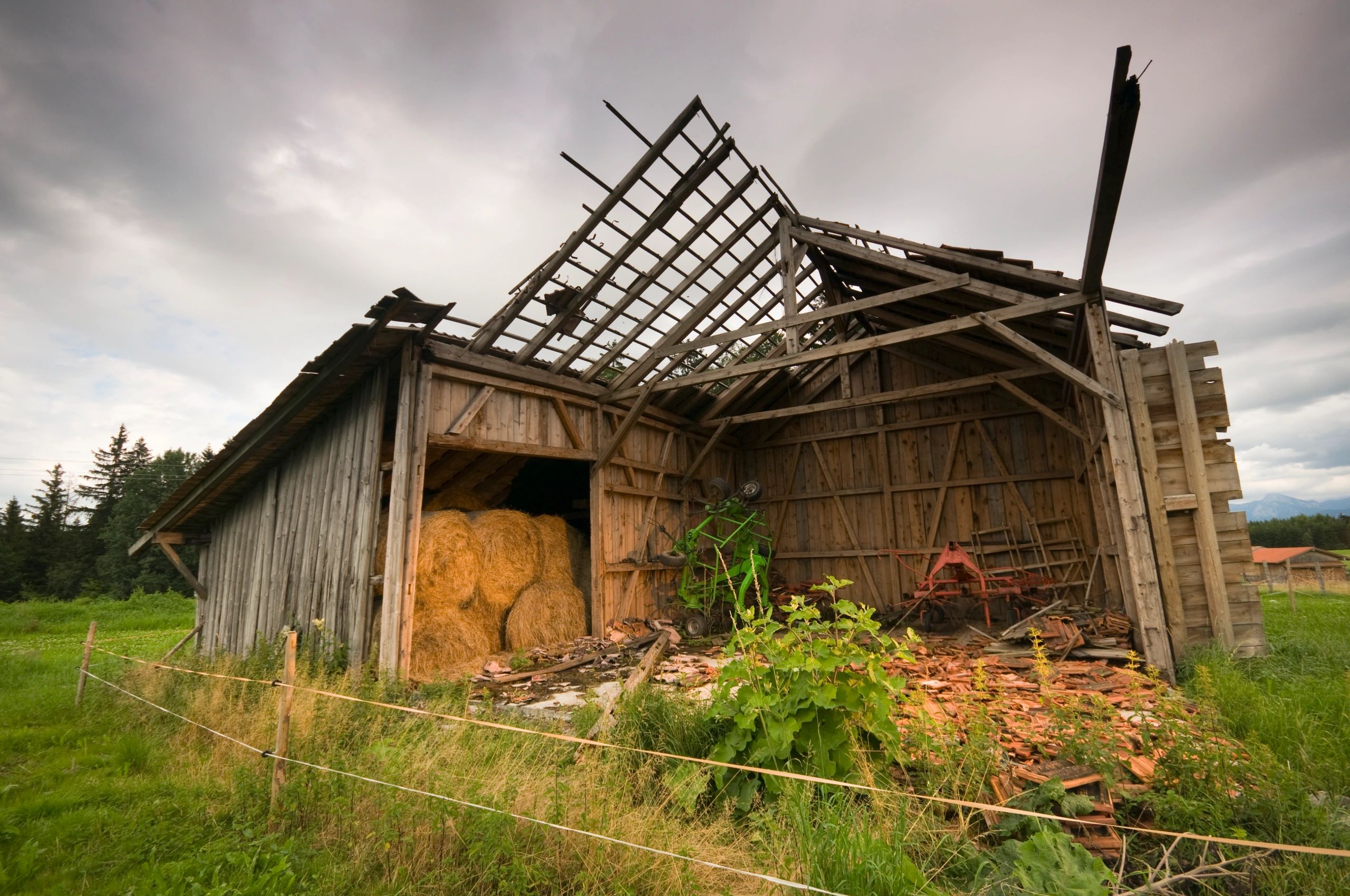 Old barn structure in a meadow representing farm builds